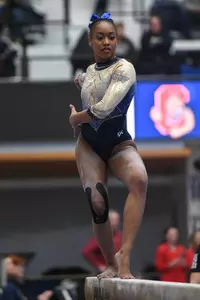 Chambliss competes on beam.