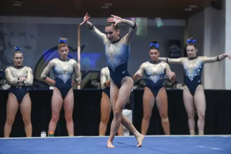 Zona competes on floor.