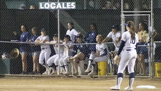 GW softball looks out from its dugout at Nancy Almaraz Stadium.