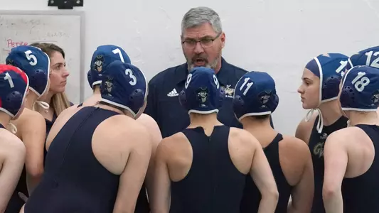 Head coach Barry King talks with his team.