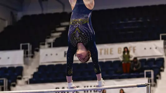 Olivia Raymond competes on bars. 
