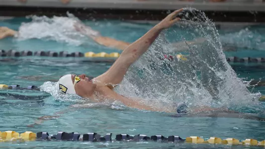 Marek Osina swims backstroke vs. Virginia Tech.