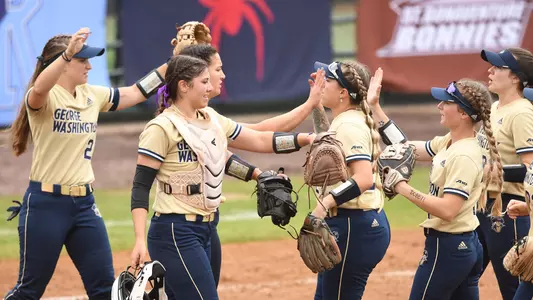 GW softball exchanges high-fives at the A-10 Championship.