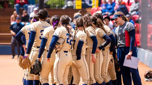 GW softball huddles at the National Invitational Softball Championship.