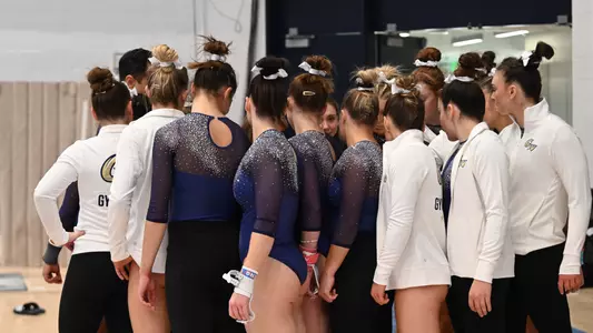 Gymnastics huddles at Lindsey Ferris Invitational