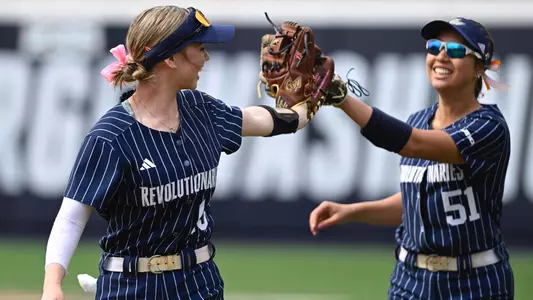 Kaylee Layfield and Cadence Gilliland high fiving at the GW Softball Field