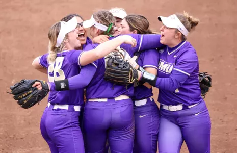 JMU softball celebrates after victory against NC State.