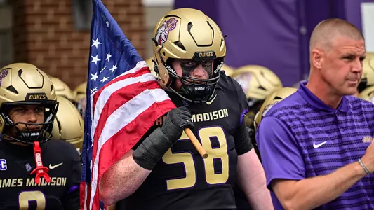 Griffin Hart runs out of the tunnel prior to JMU's game against Wagner