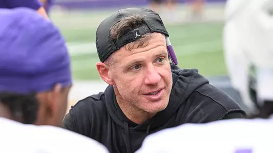 Josh Linam coaches the linebackers during a JMU football practice