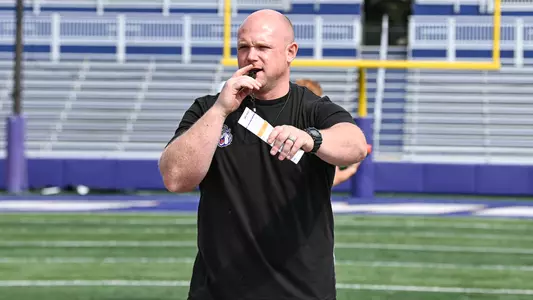 Sean Lockwood directs the players during a JMU football practice