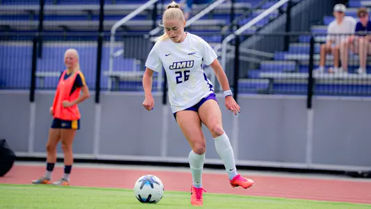 Makenna Kirk dribbles during JMU's match against UNCG