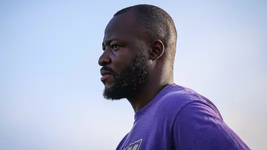 Muna Onuora coaches from the sideline during JMU women's soccer's match against NC State