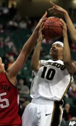 Missouri guard LaToya Bond goes to the basket against Texas Tech forward Alresha Robertson during the second half. Bond scored 24-points in their 81-75 win. (AP Photo/ Donna McWilliam)