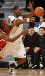J.T. Tiller and Nebraska's Jay-R Strowbridge battle for a loose ball in the first half.