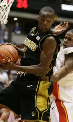 Keon Lawrence grabs a rebound in front of Iowa State's Rahshon Clark during the first half.
