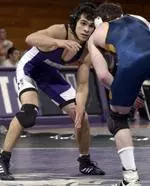 Junior John Velez shook off a shoulder injury and won the decisive match to push Northwestern over Iowa 22-19.