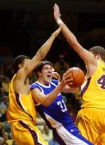 Brent Lawson and Jeff Hagen defend as Davor Duvancic drives on the basket in the first half.