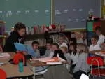 Former women's soccer player Whitney Jones reads to an elementary classroom.