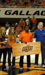 SAAC members present their check to the Oklahoma Special Olympics at halftime.