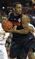 Brian Williams pulls down a rebound against Texas. Williams led the Cowboys with 16 points.