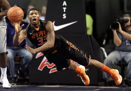 Oklahoma State guard Marcus Smart passes the ball during the first half. (AP Photo/Charlie Riedel)