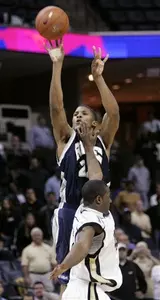 Morris Almond drained this three-pointer over UCF's David Noel to send the Owls to the semi-finals of the Conference USA Championship.