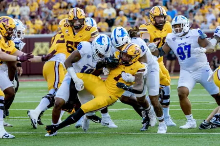 Red Murdock and Dion Crawford tackling a Minnesota player