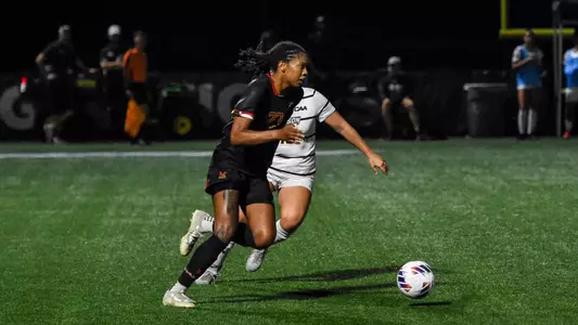 Tahirah Turnage-Morales dribbles past Towson player