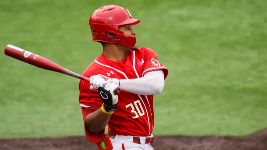 Paul Jones II hitting in a red uniform vs. Purdue