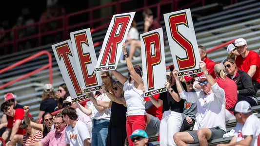 Maryland fans with the "Terps Fan" at a women's lacrosse game at SECU