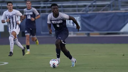 Luto Tom dribbling on field with ball against Georgia Southern
