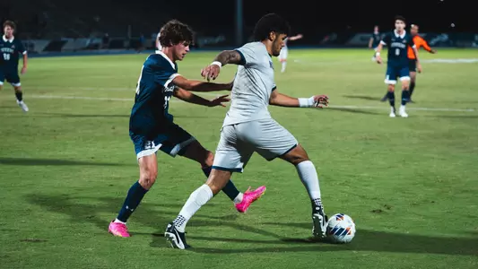Joaquin Acuna fending off defender against Queens