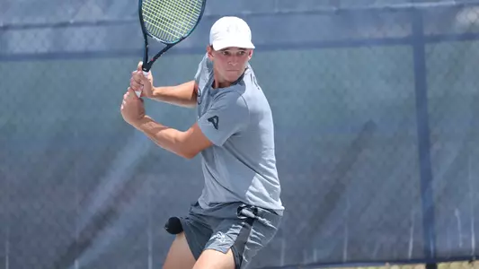 PJ Kotan returns ball in singles play