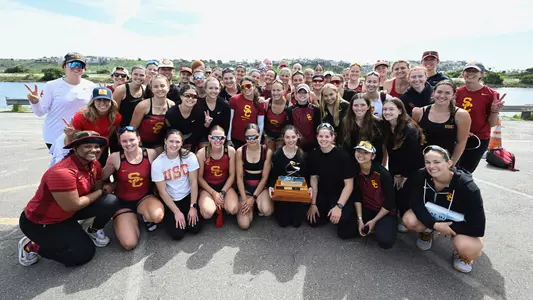 The USC Women's Rowing team poses with the trophy after beating UCLA