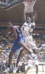 Jermaine Griffin (left) grabs a rebound away from Wyoming's Justin Williams during the Cowboys' 86-79 win on Saturday. Griffin finished with 16 points and three rebounds.