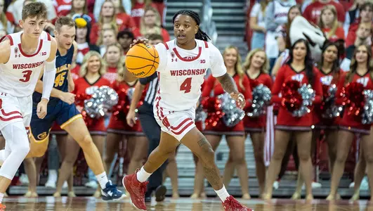 Kamari McGee dribbles the basketball during a game