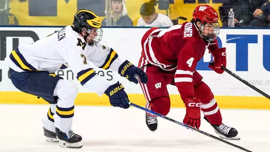 Ben Dexheimer races for the puck at Michigan