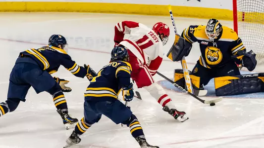 Simon Tassy shoots the puck at the Quinnipiac goaltender