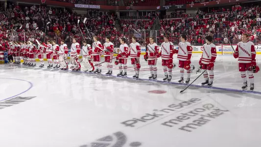 The Wisconsin men's hockey team at center ice at the Kohl Center