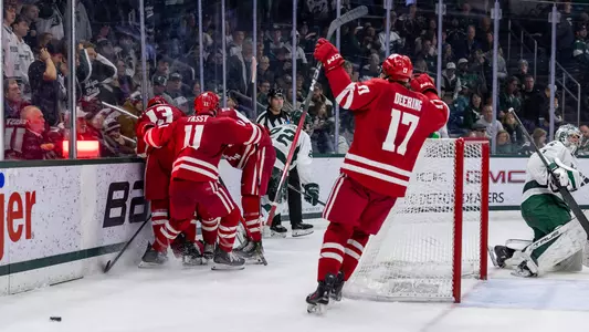 The Badger men's hockey team celebrates a goal at Michigan State