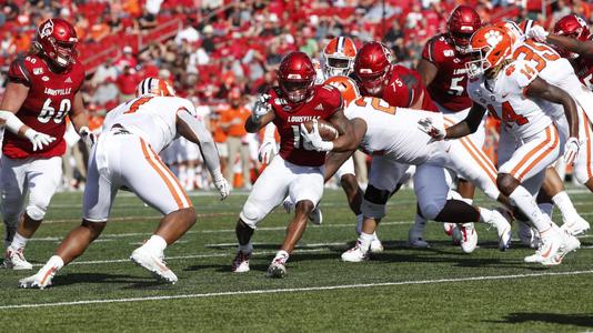 Louisville running back Javian Hawkins (10) runs from the pursuit