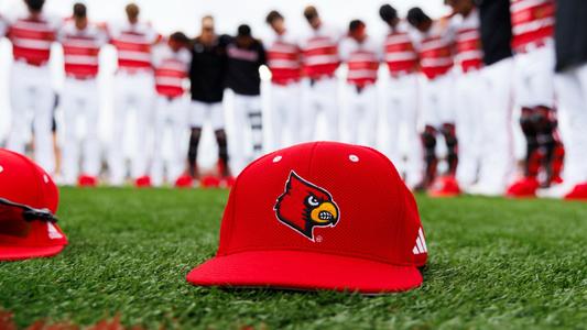 Cardinals baseball hat on the field.