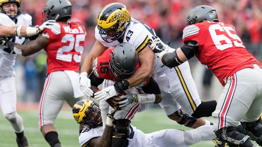 Chris Wormley of the Michigan Wolverines sacks quarterback Trace