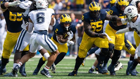 M Den selling Michigan football jerseys with players' names on the back 