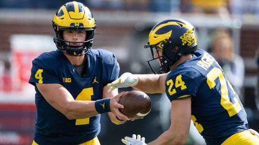 M Den selling Michigan football jerseys with players' names on the back 