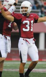 Massachusetts' Jonathan Hernandez left, breaks the tackle of