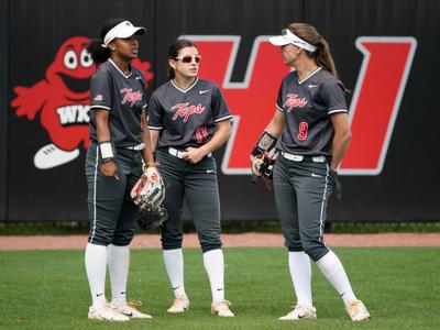 Athletic Fast Pitch Softball Player Red Black Uniform Sits Coaches