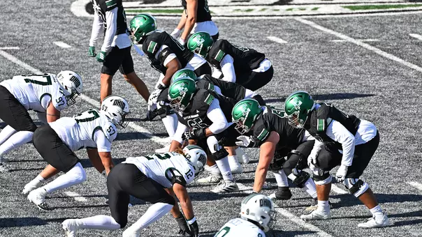 The offensive line prepares to snap the ball in the game with Ohio