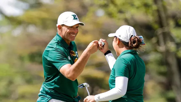 Josh Brewer (left) fist bumps Baiyok Sukterm on the 18th green at the MAC Championships after she finished her round of 69