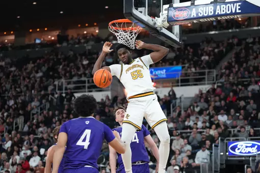 Oswin Erhunmwunse converts a dunk against Holy Cross at The Amica Mutual Pavilion.